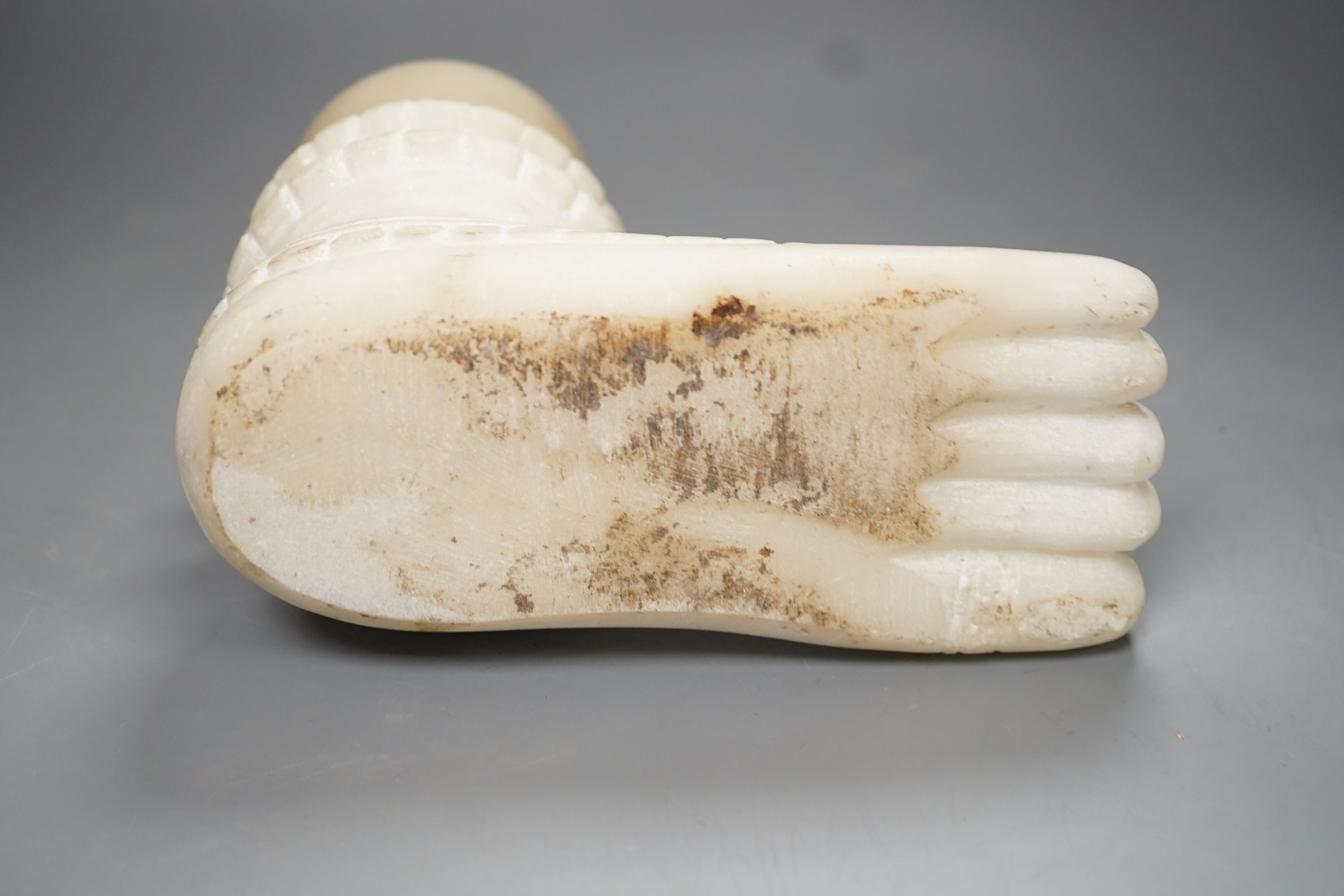 An Indian white marble foot of a deity - 18cm high